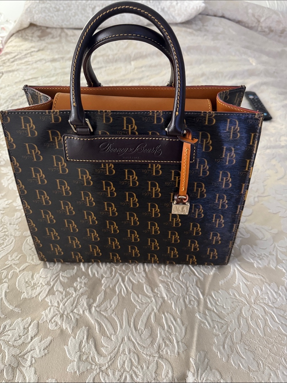 Dooney & Bourke Black and Tan Logo-Print Satchel with Gold Hardware